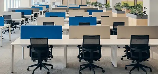 Modern open-plan office space featuring clean workstations, ergonomic chairs, and sanitized carpets provided by professional office cleaning services in Cincinnati, OH.